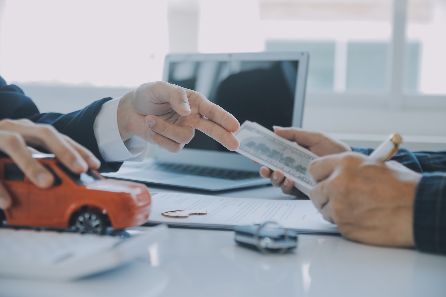 Closeup asian male people car salesman or sales manager offers to sell a car and explains and reads the terms of signing a car contract and insurance.